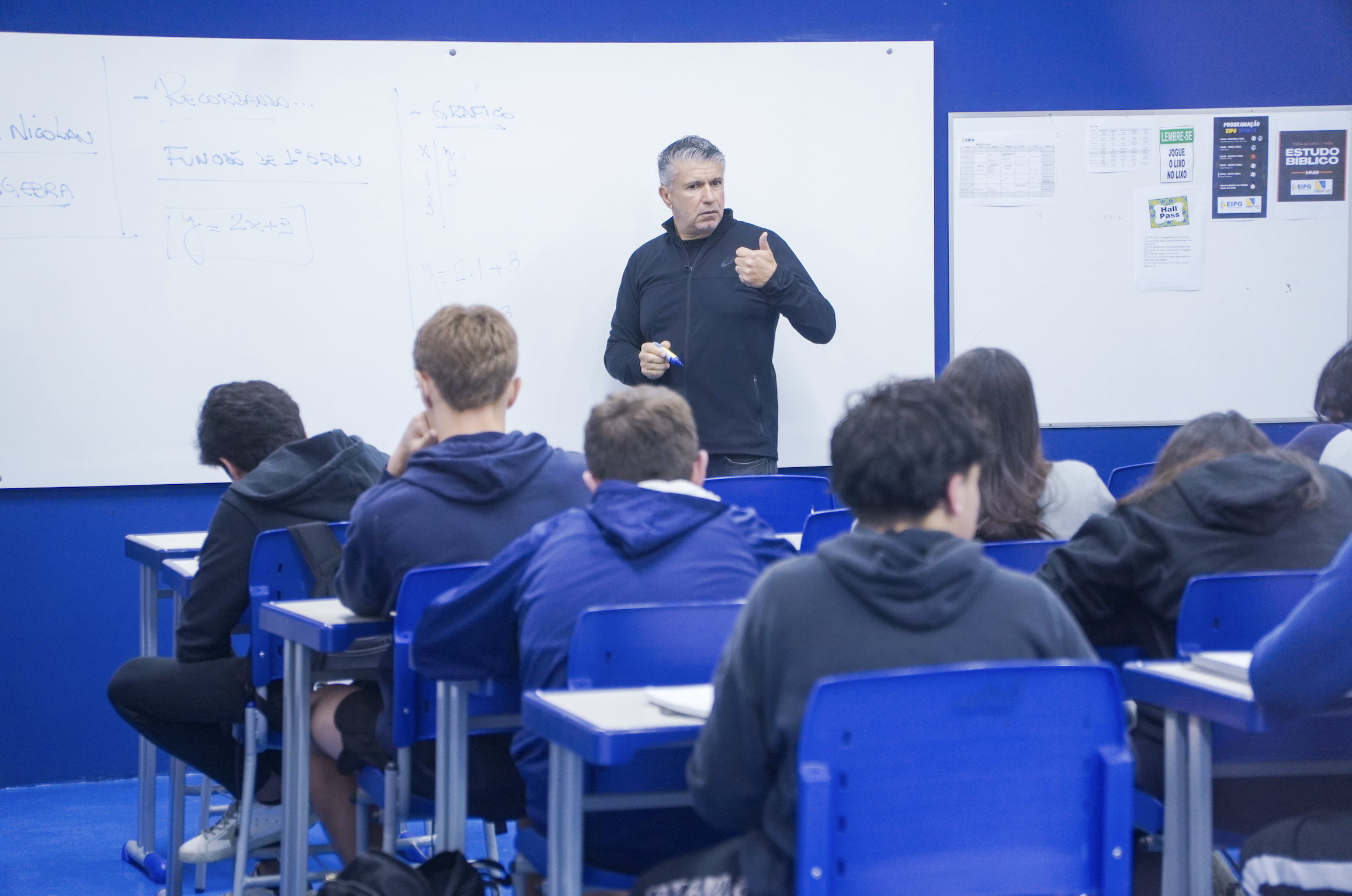 Photo of a study hall with wooden tables and chairs.